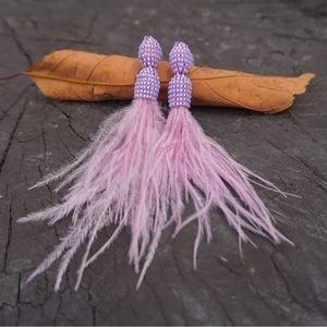 Statement earrings from Colombia made with the Miyuki technique and feathers.